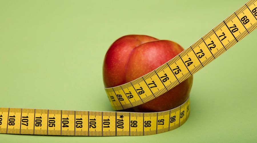 image of measuring tape around an apple